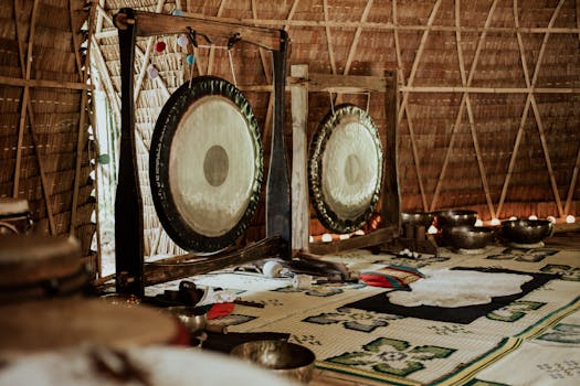 Peaceful interior of a meditation room featuring gongs and Tibetan singing bowls for mindfulness practice.